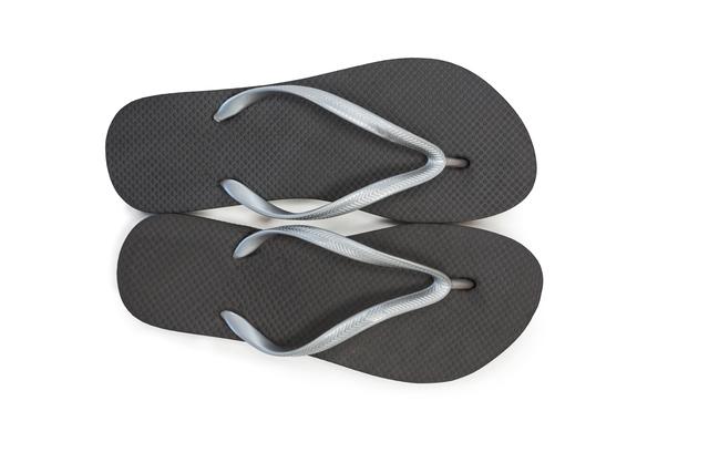 Pair of black beach flip flop slipper on white background