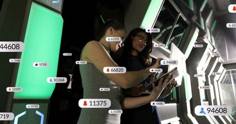 Female Technicians Analyzing Digital Data in Futuristic Control Room