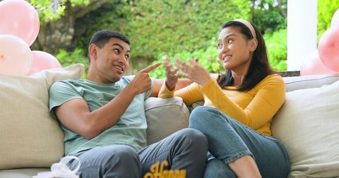 Couple relaxing outdoors sharing snacks in casual setting