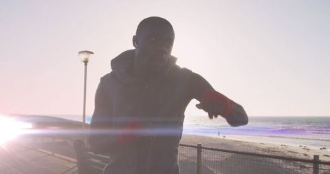 Energetic African American Man Running Along Scenic Beach