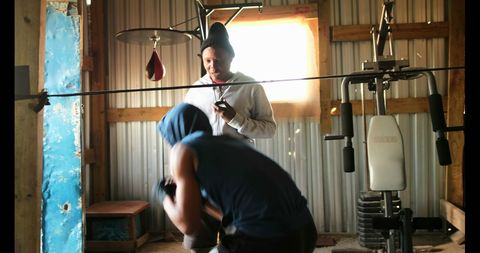 Young Boxer Training with Coach in Gym Setting
