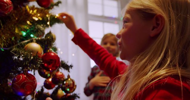 Children Decorating Christmas Tree with Ornaments Inside Cozy Home - Download Free Stock Images Pikwizard.com