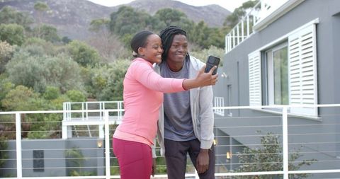 African American Couple Taking Selfie on Terrace Wearing Activewear, Outdoor Lifestyle
