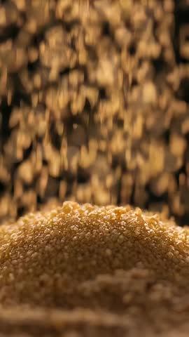 Falling Golden Grains Building Mound on Tray Vertical Slow-Motion Macro Video