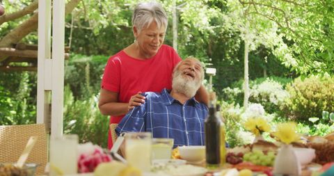Joyful Senior Couple Laughing Together in Sunlit Garden