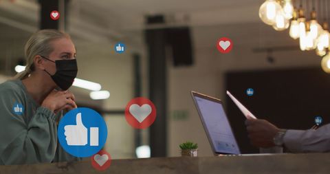 Multiracial business meeting with floating social media icons