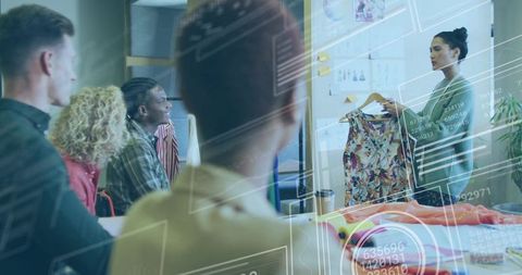 Fashion designer presenting floral dress for creative team with augmented reality overlays