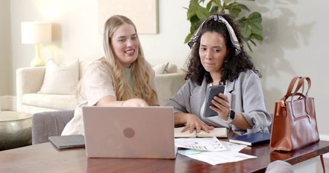 Colleagues partnering at home workspace for creative project