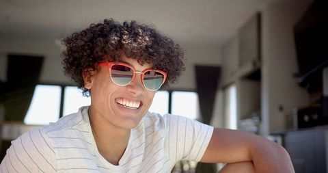 Smiling Young Man with Sunglasses Relaxing at Home