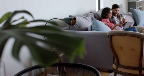 Happy Couple Relaxing and Using Tablet in Cozy Living Room - Download Free Stock Images Pikwizard.com