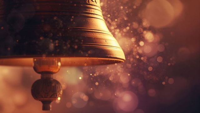 Vintage hanging brass bell with dusty ambient glow