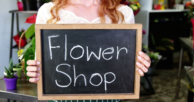 Woman in Flower Shop Holding Chalkboard Sign - Download Free Stock Images Pikwizard.com