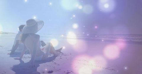 Couple lounging on beach wearing swimwear, woman in sun hat, pastel bokeh glow