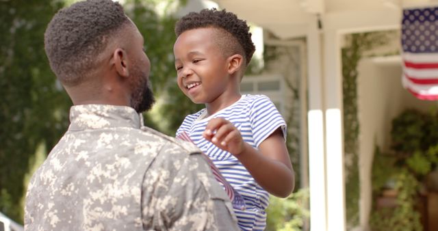 Happy african american son with flag welcoming home soldier father - Download Free Stock Photos Pikwizard.com