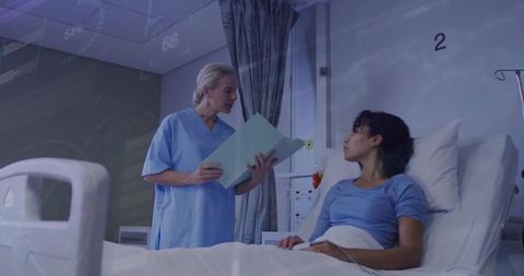 Nurse discussing patient care at bedside in hospital setting