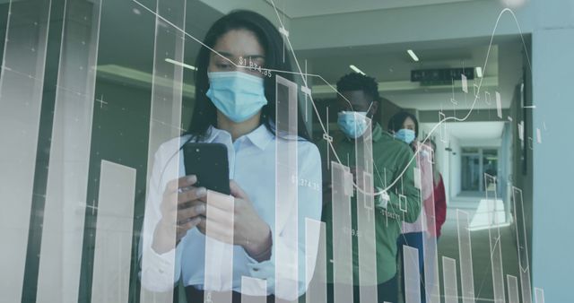 Businesspeople wearing medical masks viewing mobile screen with financial graphs overlay - Download Free Stock Images Pikwizard.com