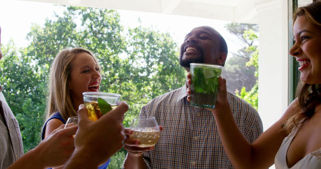 Friends Celebrating with Drinks on a Sunny Balcony - Download Free Stock Images Pikwizard.com