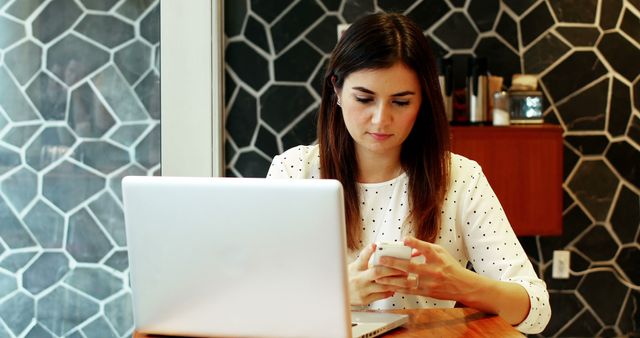 Focused Woman Working With Laptop and Smartphone in Modern Office - Download Free Stock Images Pikwizard.com