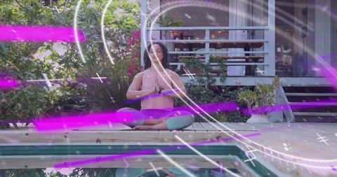 Woman Meditating on Pool Deck with Neon Light Trails for Outdoor Yoga Mindfulness