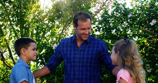 Joyful Father Spending Time with Children in Garden - Download Free Stock Images Pikwizard.com