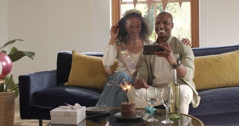 Joyful Couple Celebrating Birthday with Selfie at Home