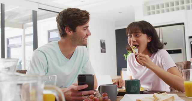 Friendly Couple Sharing Breakfast at Sunlit Kitchen Table - Download Free Stock Images Pikwizard.com