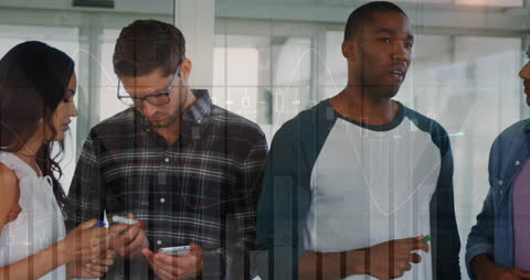 Diverse Team Analyzing Financial Data Visualization in Office