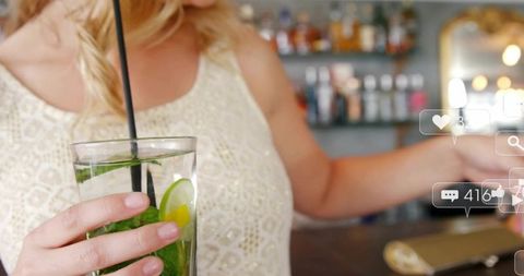 Woman Enjoying Cocktail at Trendy Bar Downtown Photo