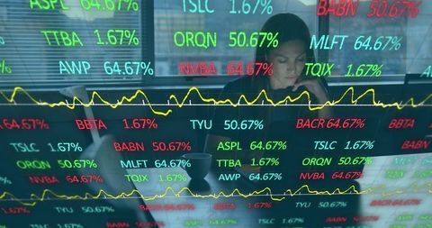 businesswoman analyzing stock data on laptop in modern office - Download Free Stock Images Pikwizard.com