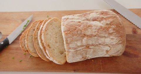 Artisan crunchy sourdough loaf on wooden board