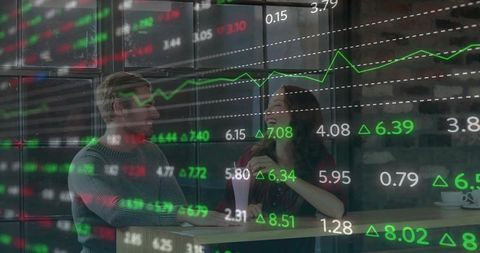 Professionals Analyzing Stock Trends in Modern Cafe Lounge