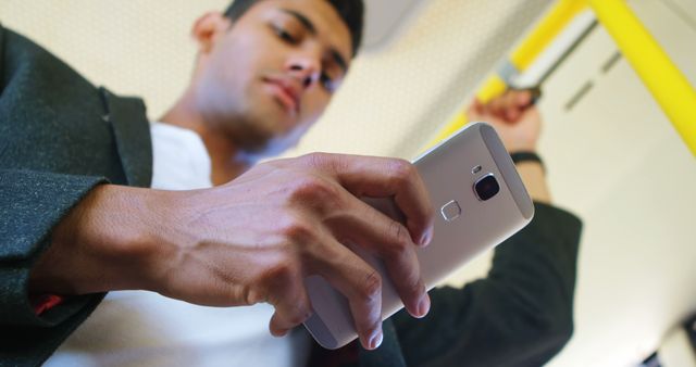 Man Using Smartphone in Public Transport Holding on Handrail - Download Free Stock Images Pikwizard.com