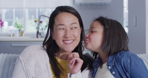 Joyful Moment Between Mother and Daughter in Cozy Home