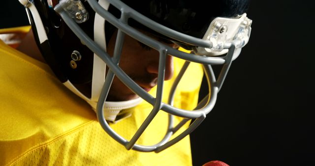 Focused Football Player in Full Gear Looking Down - Download Free Stock Images Pikwizard.com