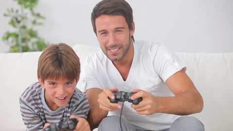 Joyful Father and Son Enjoying Video Game Together