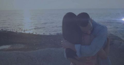 Romantic Couple Hugging on Scenic Beach at Sunset