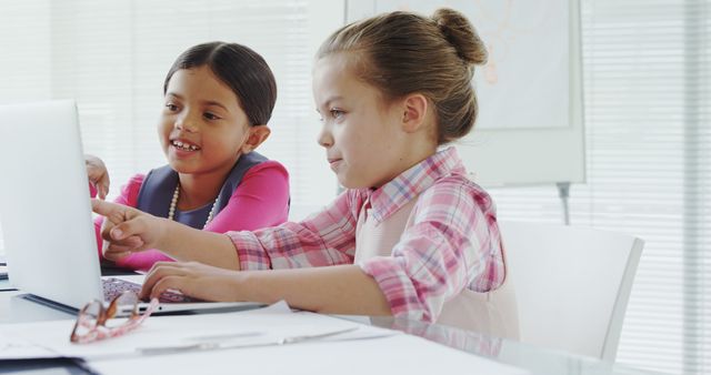 Two Children Exploring Laptop in Bright Modern Classroom - Download Free Stock Images Pikwizard.com