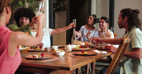 Friends Toasting at Outdoor Dinner Party Celebration