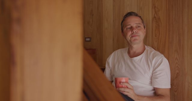 Man Relaxing with Coffee Cup Inside Wooden Home - Download Free Stock Images Pikwizard.com