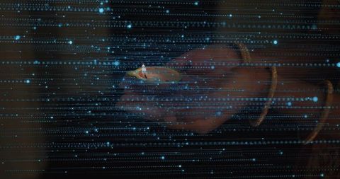 Indian hand holding lit diya with gold bangles and blue digital starfield projection minimalist