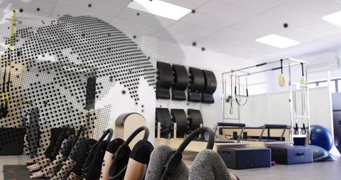 Group pilates mat class using rings for core strength and balance in modern studio