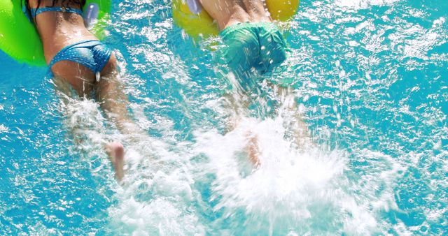 Two Children Splashing in Pool with Colorful Floats on a Sunny Day - Download Free Stock Images Pikwizard.com