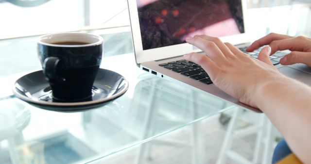 Person Typing on Laptop with Coffee Cup on Glass Table - Download Free Stock Images Pikwizard.com