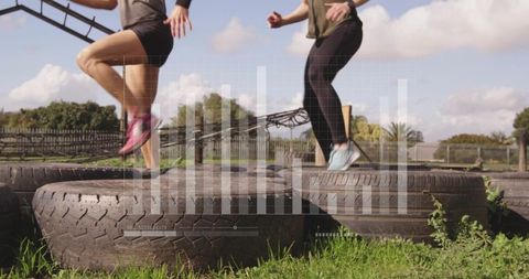 Women engaging in fitness drill on tires with composite analytics