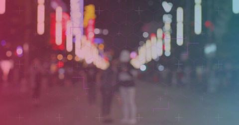 Blurry pedestrians on vibrant night street with neon lights