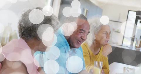 Joyful Retirement: Three Seniors Enjoy Breakfast in Cozy Kitchen