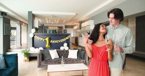 Couple Celebrating Anniversary with Champagne in Stylish Living Room