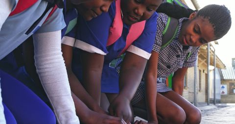 Students collaborating on school project outside