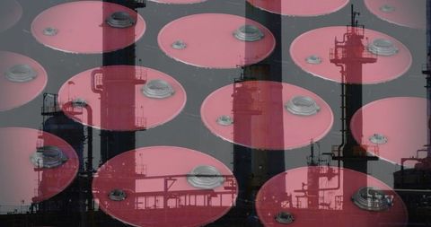 Overlay of oil barrels and industrial factory silhouettes