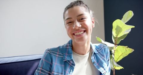 Smiling Teenage Girl Relaxing in Sunny Home Environment
